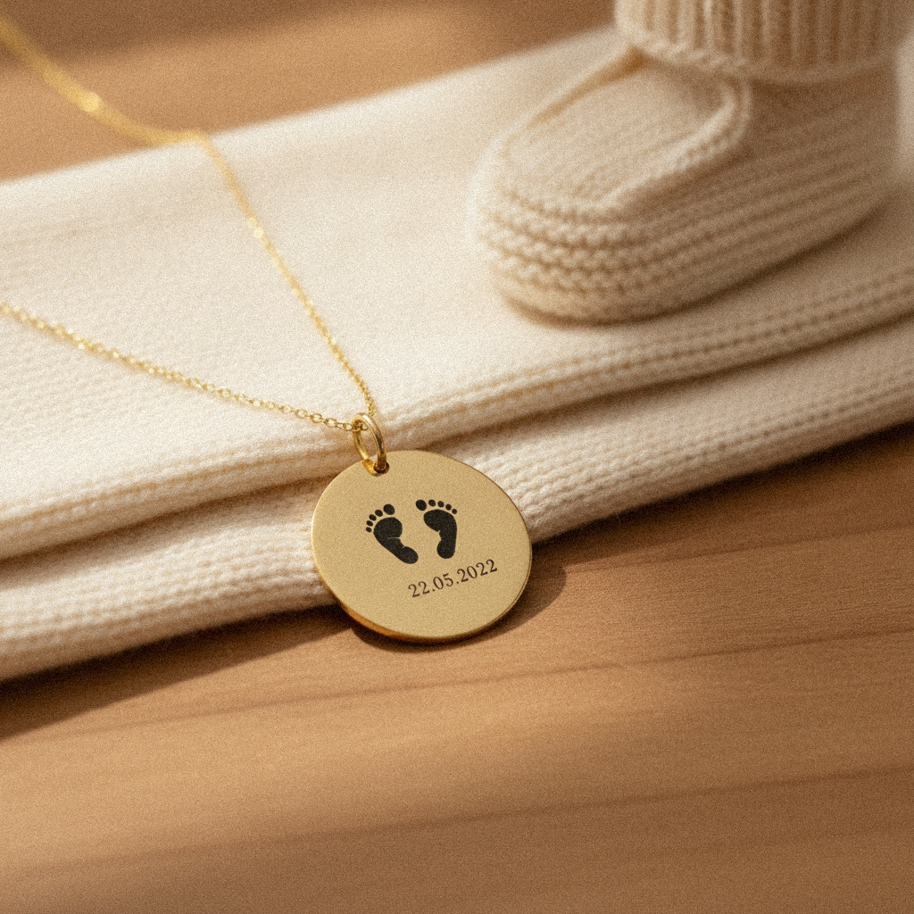 Footprint pendant with a tiny knitted baby bootie